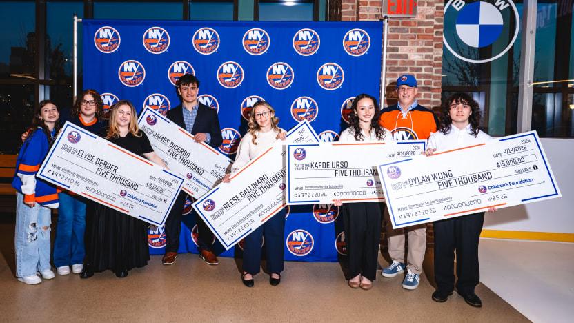 kids holding oversized checks